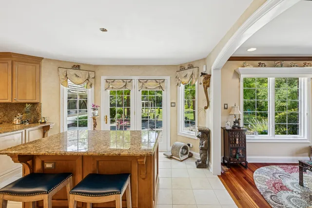 a dining room with furniture and large windows