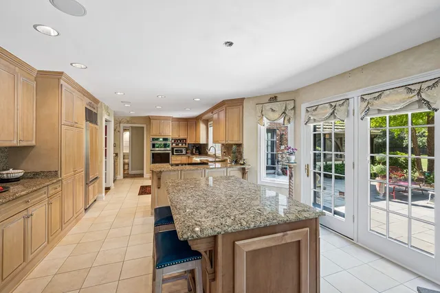 a kitchen with stainless steel appliances granite countertop a stove and a sink