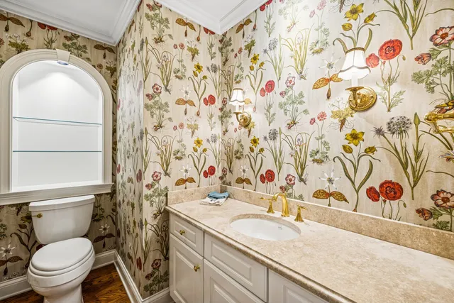 a bathroom with a sink and mirror with toilet