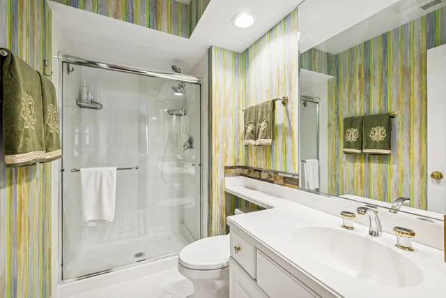 a bathroom with a sink toilet and shower