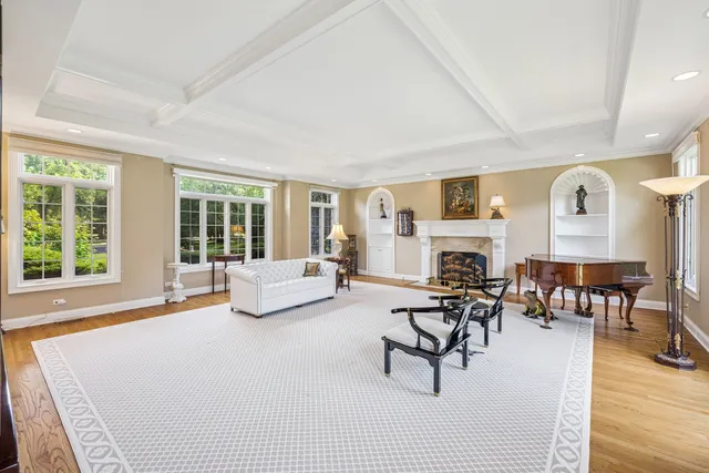 a living room with fireplace furniture and a table