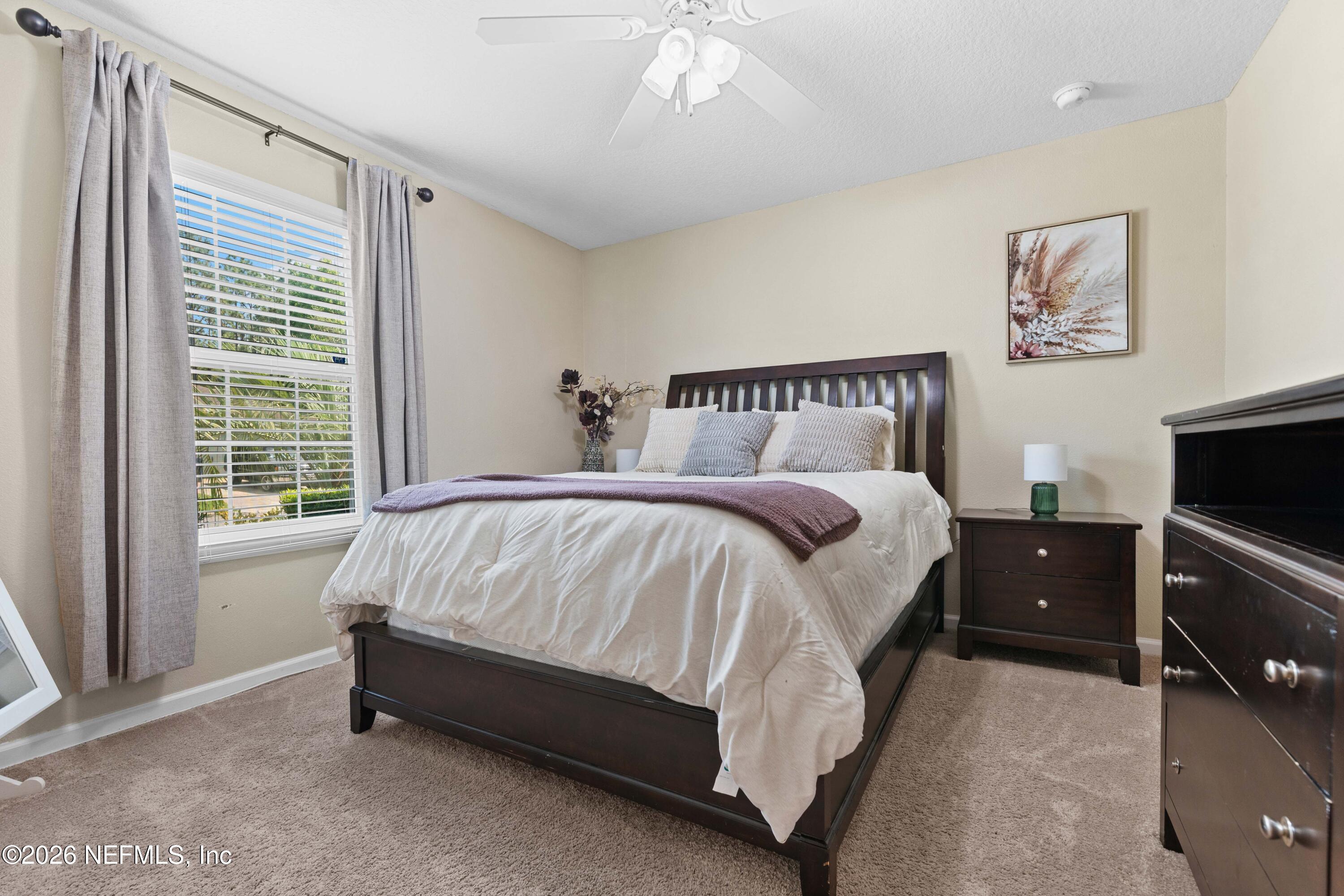 6178 Daylilly Road Macclenny, FL 32063 - Photo 21 of 29 a bed sitting in a bedroom next to a window
