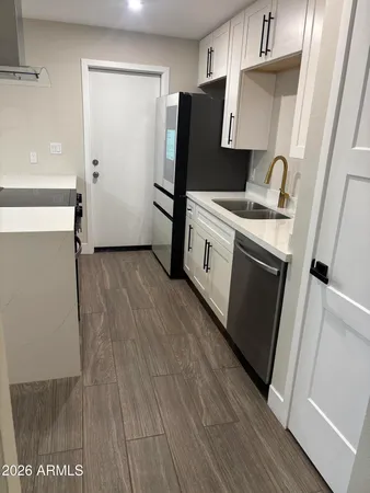 a kitchen with a refrigerator and a stove top oven