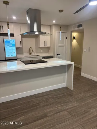 a view of kitchen with stainless steel appliances granite countertop a sink a stove and a wooden floors