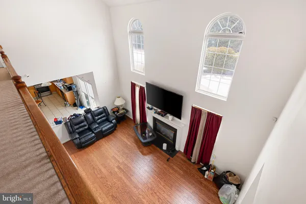 a living room with furniture a flat screen tv and a window