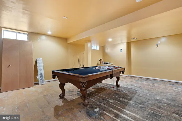 a room with wooden floor and furniture