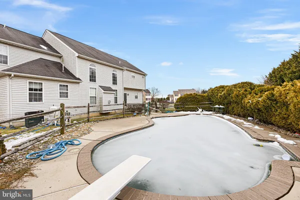a swimming pool with outdoor seating and yard