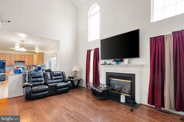 a living room with furniture fireplace and flat screen tv