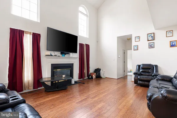 a living room with furniture flat screen tv and a fireplace