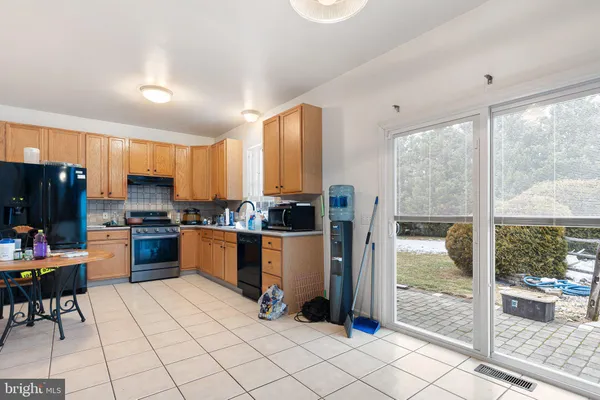 a kitchen with a refrigerator and a stove top oven