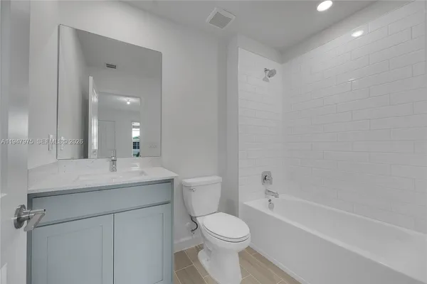 a bathroom with a sink toilet vanity and shower
