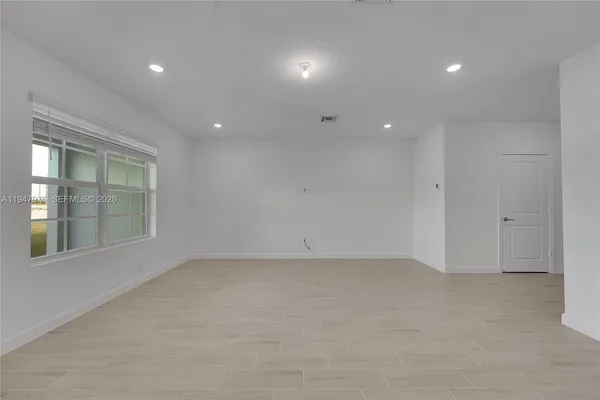 an empty room with a empty space and windows