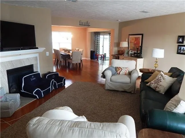 a living room with furniture floor and a flat screen tv