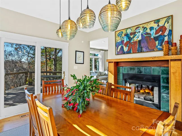 a living room with furniture a fireplace and a floor to ceiling window