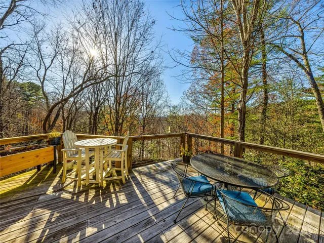 a view of a balcony with wooden floor and outdoor seating