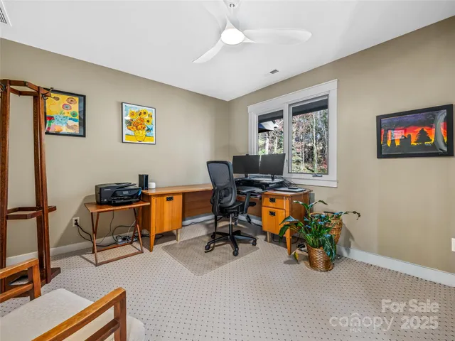 a view of a workspace with furniture and a workspace