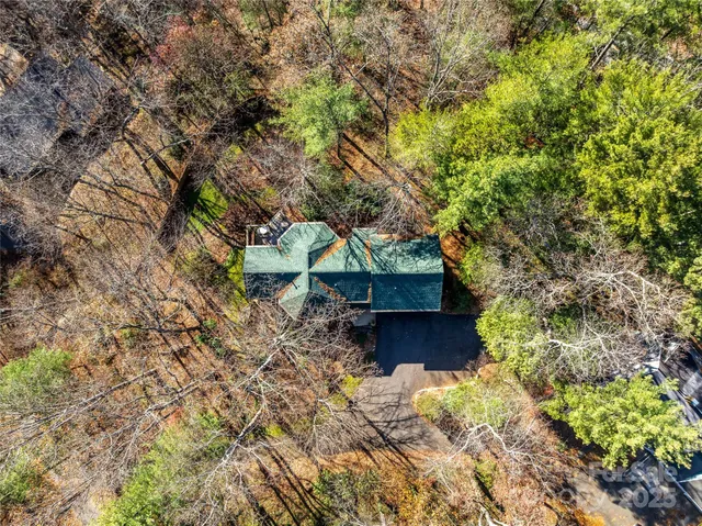 an aerial view of residential house with space and mountain view