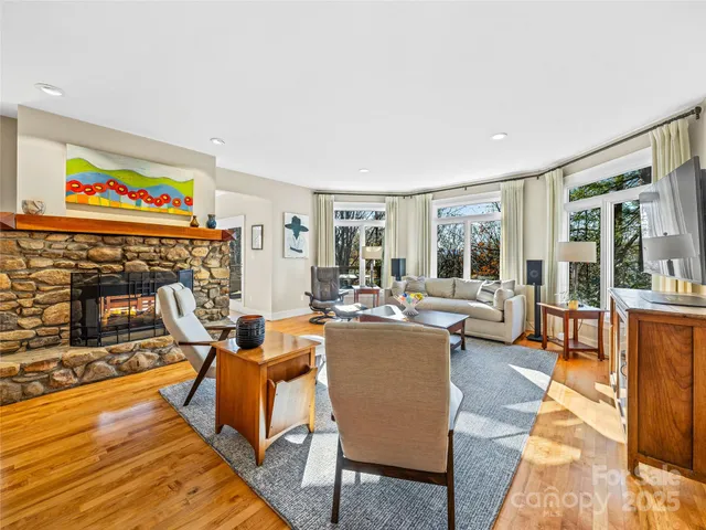 a living room with fireplace furniture and a flat screen tv