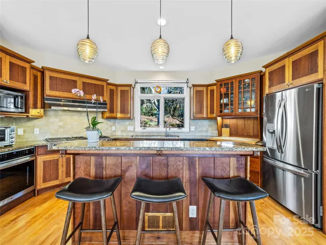 a kitchen with stainless steel appliances a sink and a refrigerator