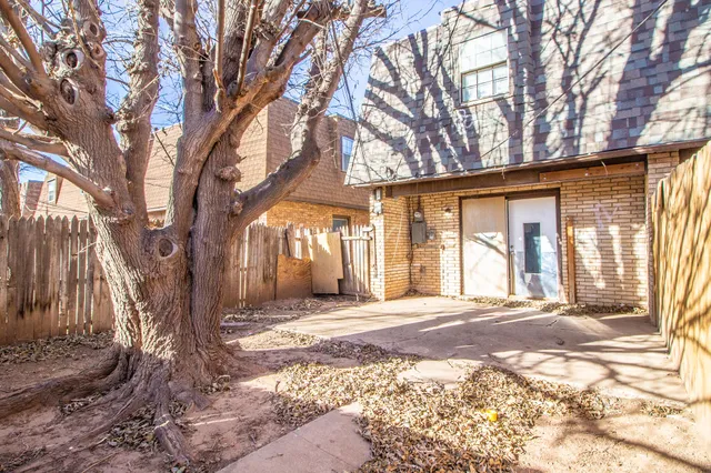 a view of a house with a yard and trees