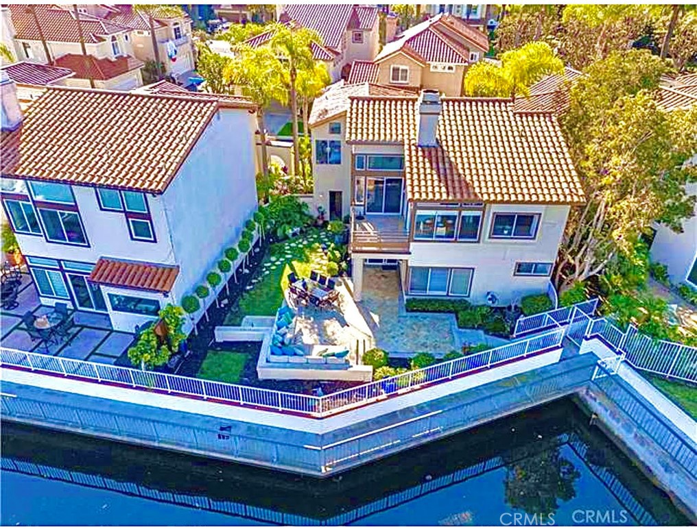 a front view of a house with a yard and potted plants