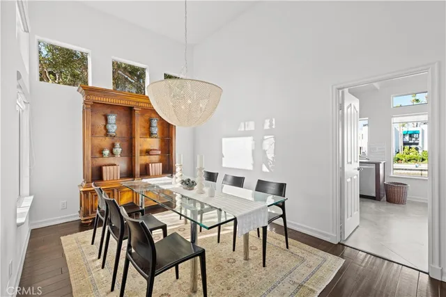 a dining room with furniture wooden floor and a chandelier