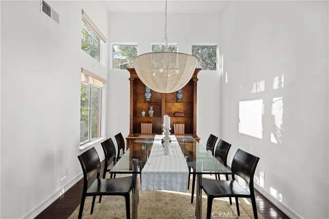 a dining room with furniture and a floor to ceiling window