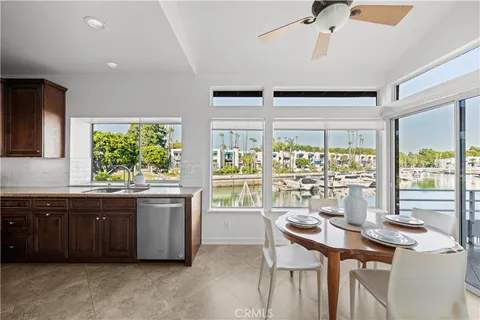 a large bed sitting in a bedroom next to a window and a lamp