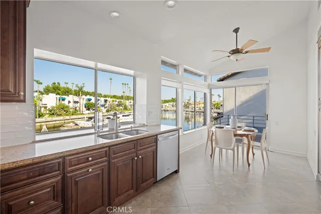 a kitchen with granite countertop a refrigerator and cabinets