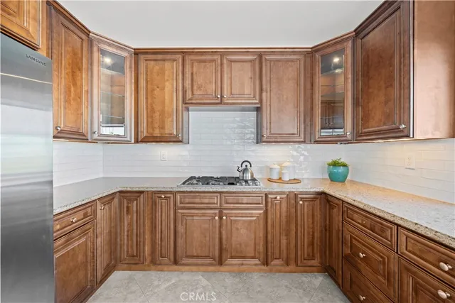 a kitchen with stainless steel appliances granite countertop a refrigerator and a sink