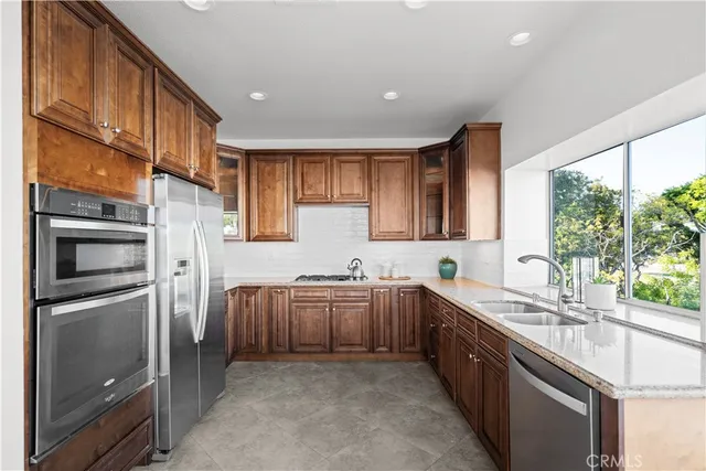 a spacious en suite bathroom with a double vanity sink and a mirror