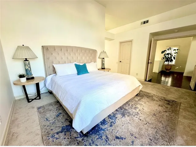 a view of a chairs with potted plants in front of house