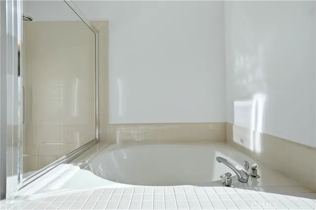 a bedroom with a large bed and a large window