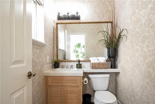 a bathroom with a sink vanity and mirror