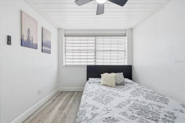 a bedroom with a bed and window