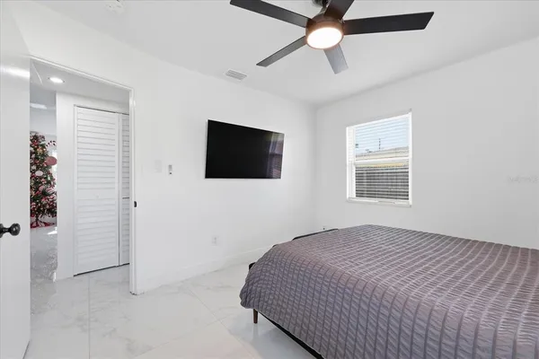 a bedroom with a bed and a flat screen tv
