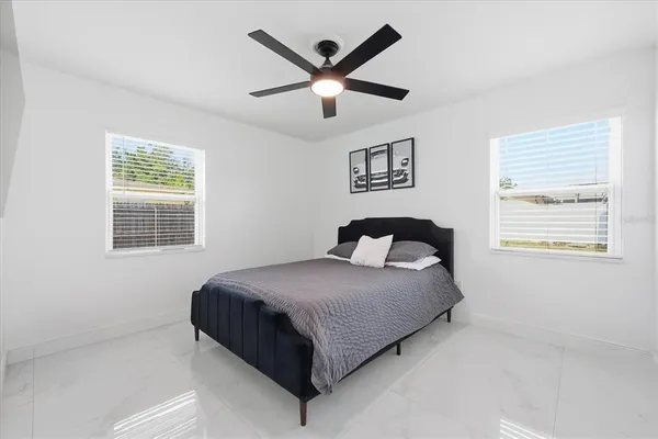 a bedroom with a bed and window