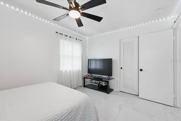 a bedroom with a bed and a flat screen tv