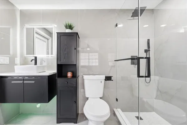 a bathroom with a toilet a sink and shower