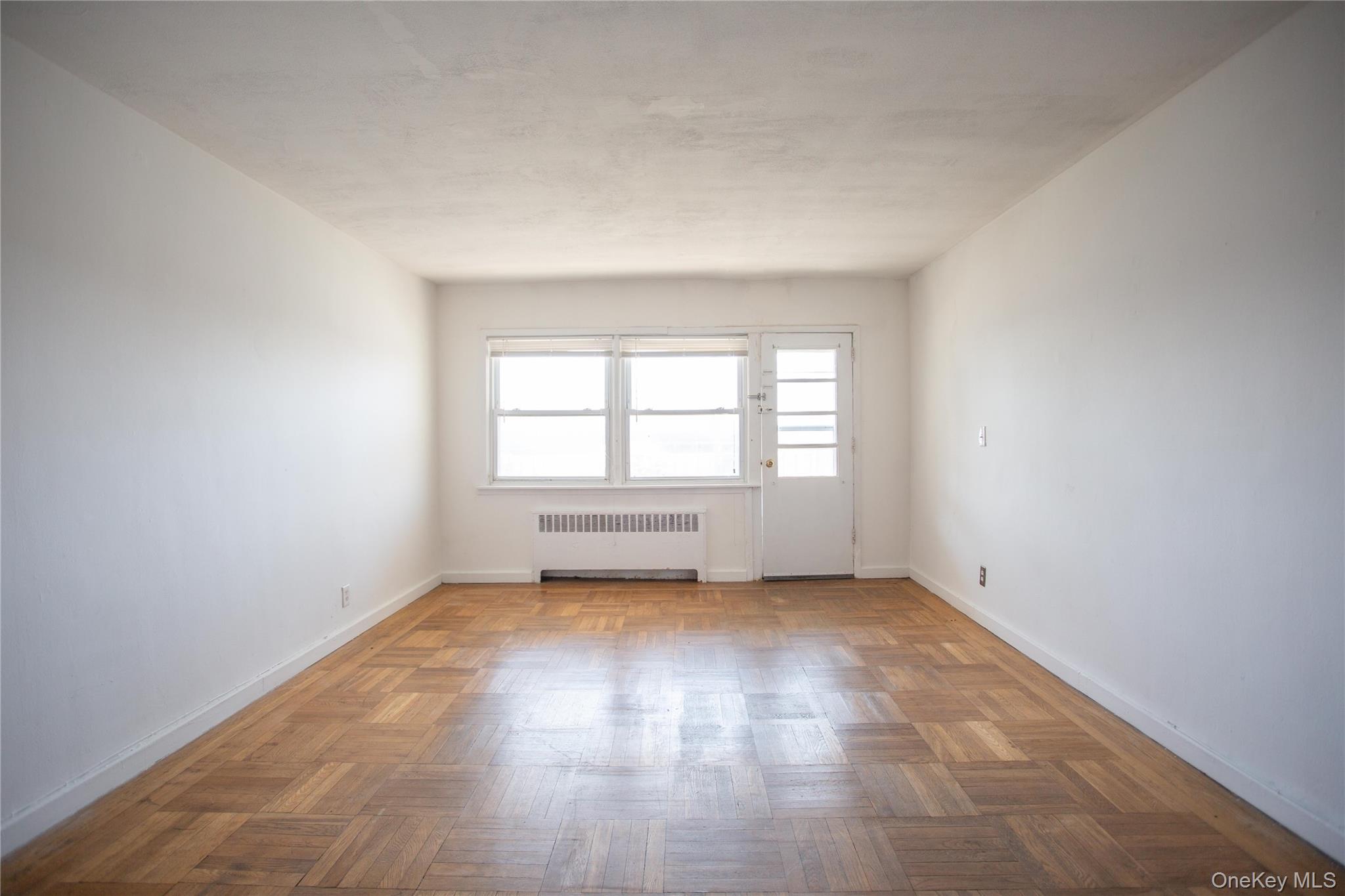 345 Shore Road, Unit 1E Long Beach, NY 11561 - Photo 5 of 13 an empty room with a window