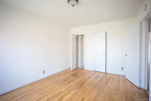 a view of a room with wooden floor and white walls