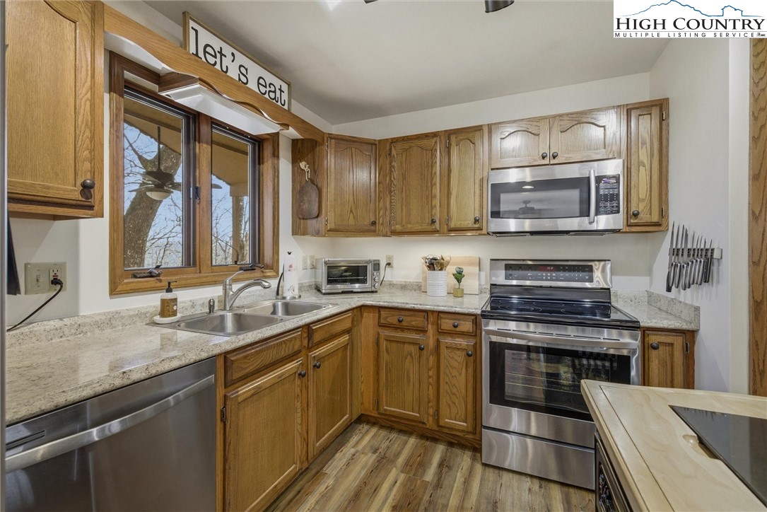 25 Poke Road Newland, NC 28657 - Photo 12 of 33 a kitchen with stainless steel appliances a stove sink microwave and cabinets