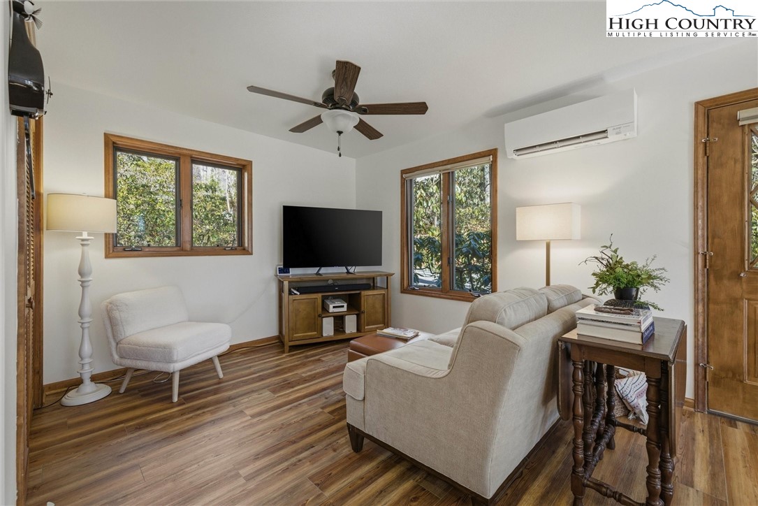 25 Poke Road Newland, NC 28657 - Photo 4 of 33 a living room with furniture a flat screen tv and a large window