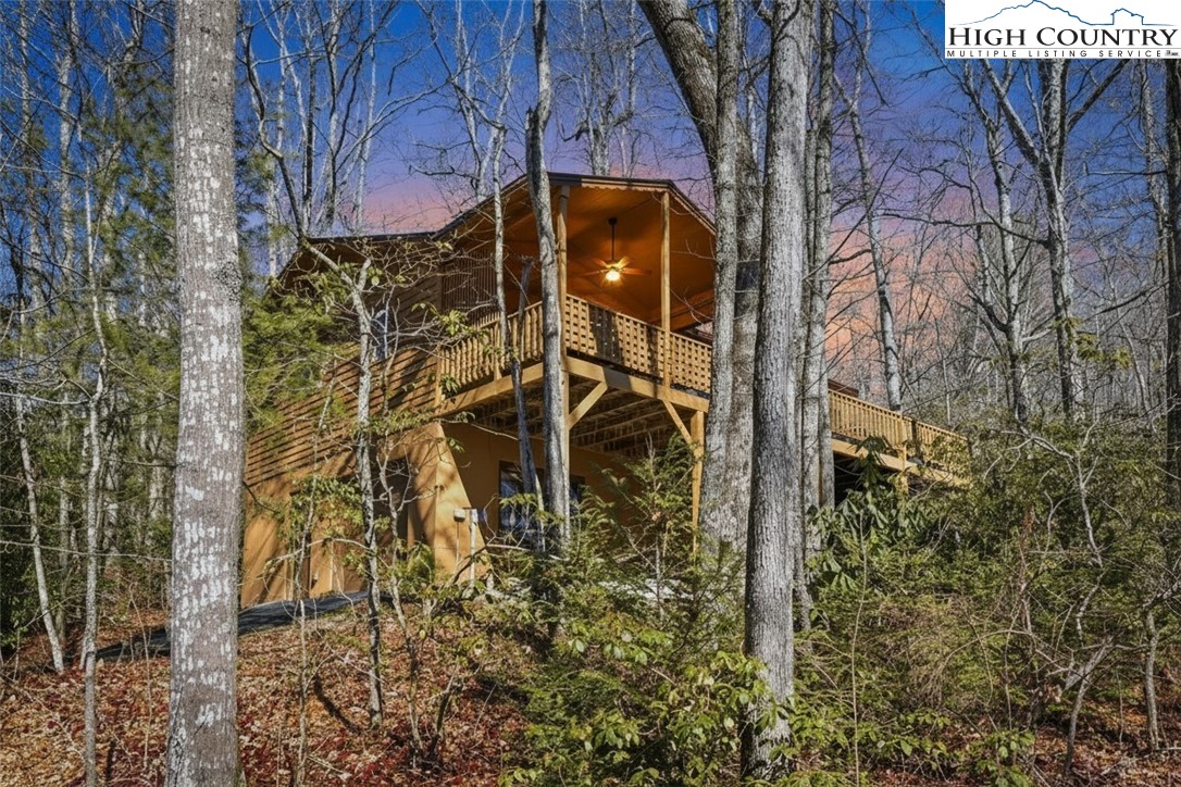 25 Poke Road Newland, NC 28657 - Photo 6 of 33 a yellow house with a trees in front of it