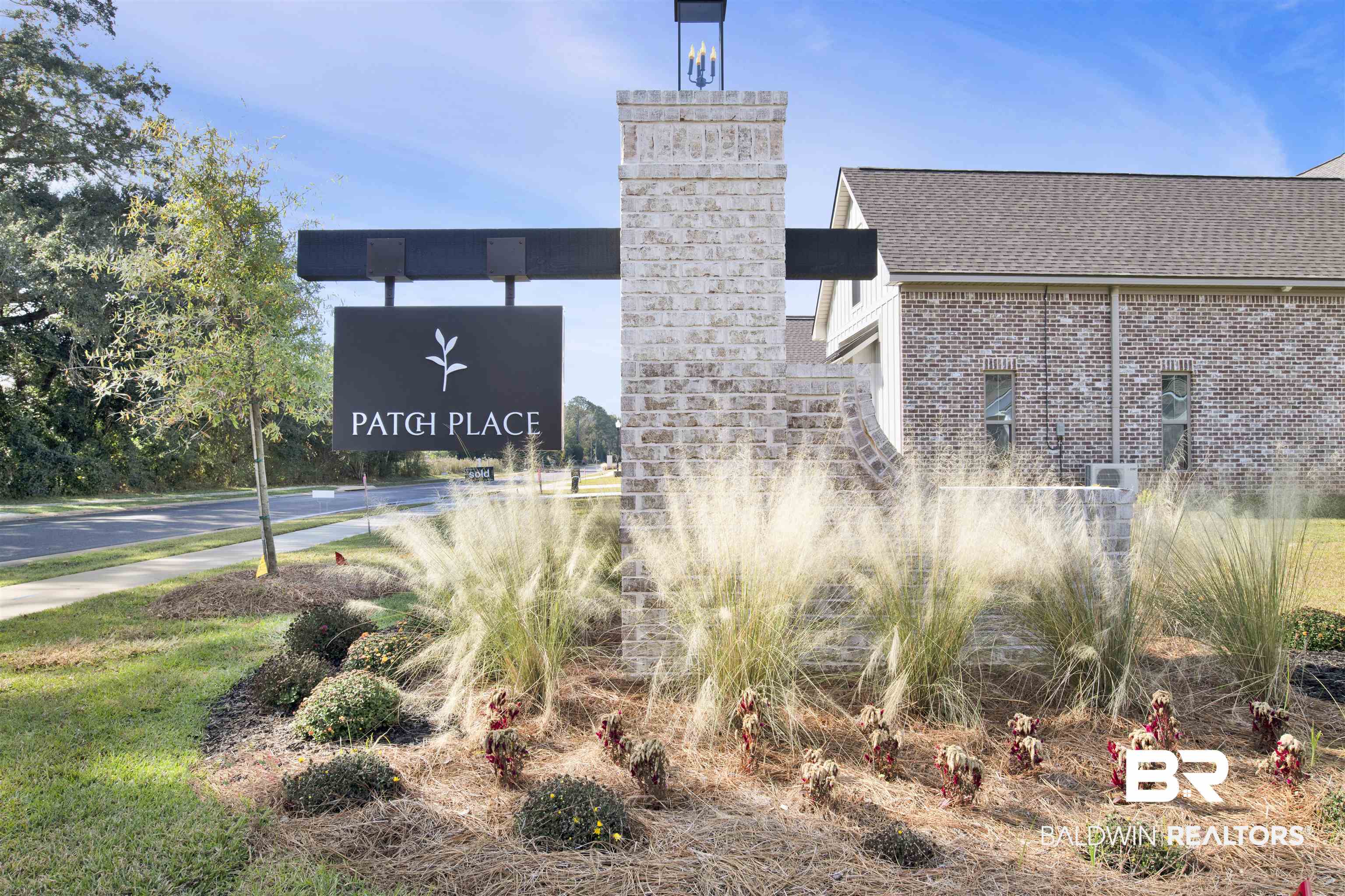 27459 Patch Pl Loop Daphne, AL 36526 - Photo 2 of 2 Brick entry monument featuring an integrated coach light and a black informational sign