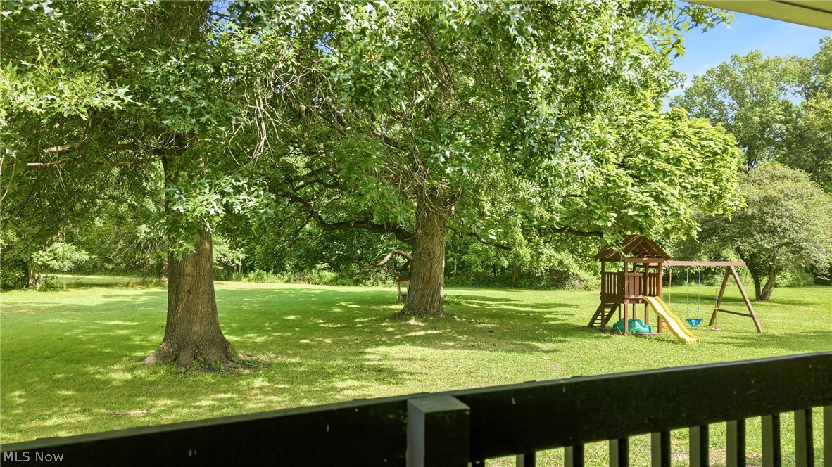 1501 Ohltown McDonald Road Mineral Ridge, OH 44440 - Photo 27 of 32 Expansive green lawn framed by mature trees, offering a private outdoor space