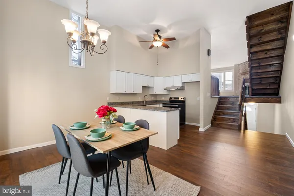 a view of a dining room with furniture wooden floor and chandelier