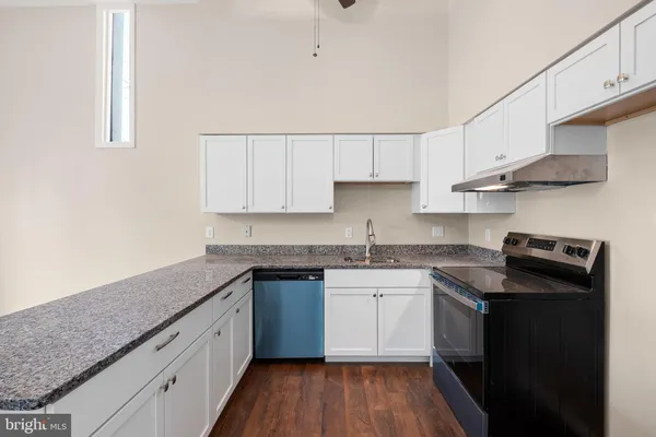 a kitchen with stainless steel appliances granite countertop a sink stove and cabinets