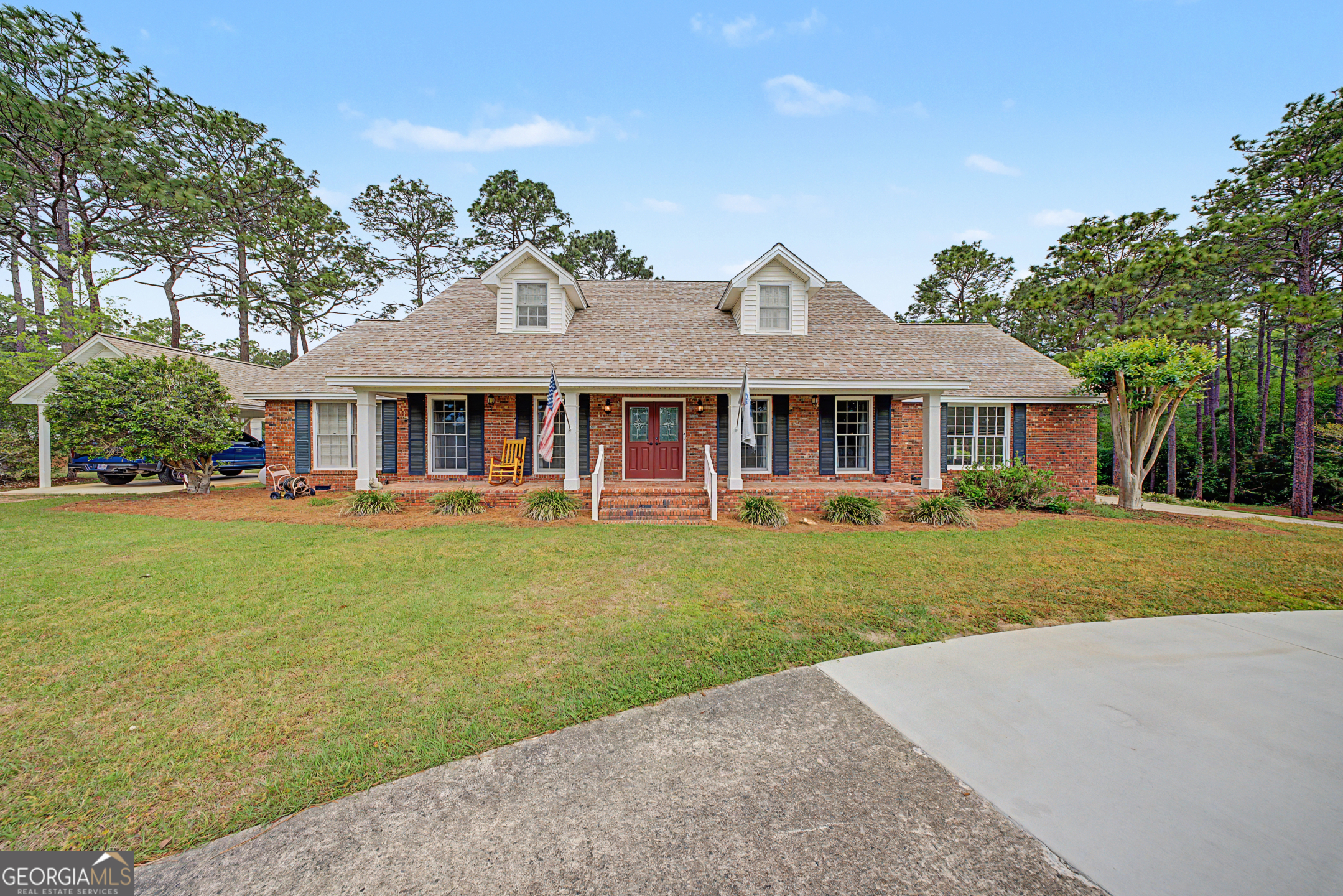 306 Holly Trail Moultrie, GA 31768 - Photo 1 of 40 a front view of a house with a garden and trees