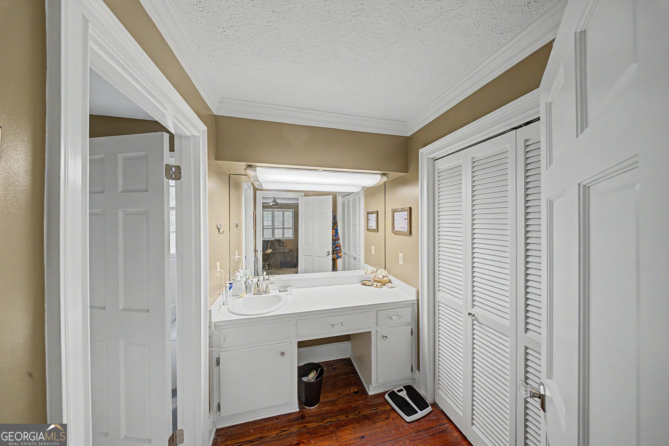 306 Holly Trail Moultrie, GA 31768 - Photo 13 of 40 a view of hallway with sink and wooden floor